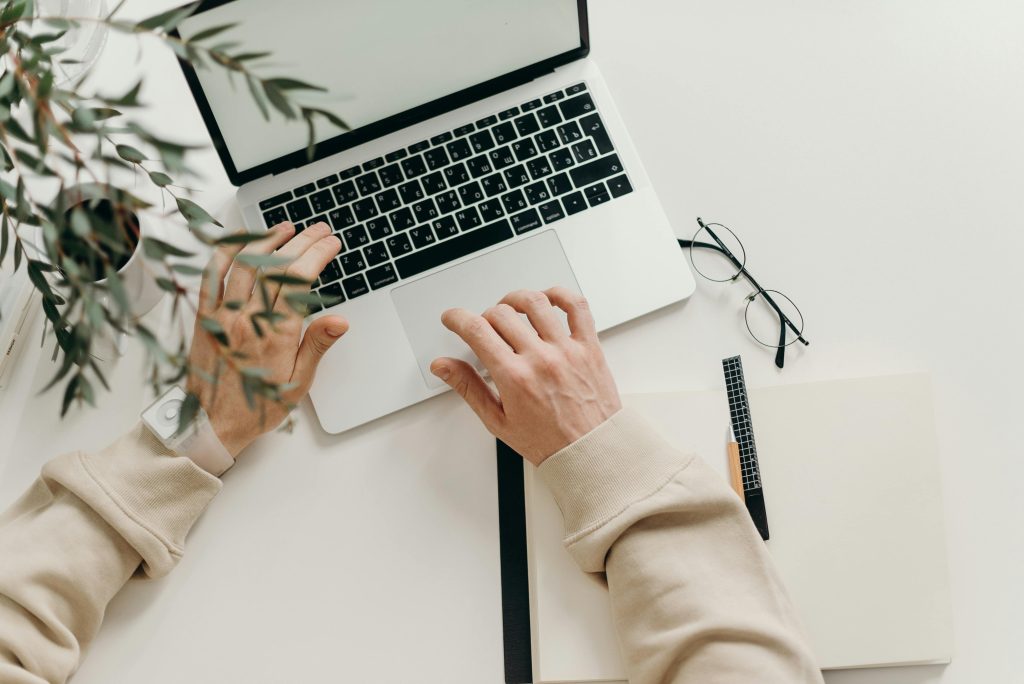 A man typing on a laptop. This is the fourth choice of side hustle ideas on this list.