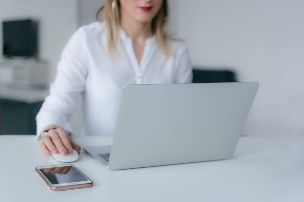 A woman searching and browsing on a computer. This is the third choice side hustle ideas.