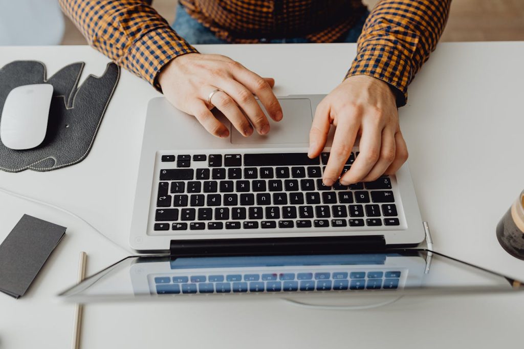 Building an Email Marketing Strategy A person typing on a laptop keyboard.