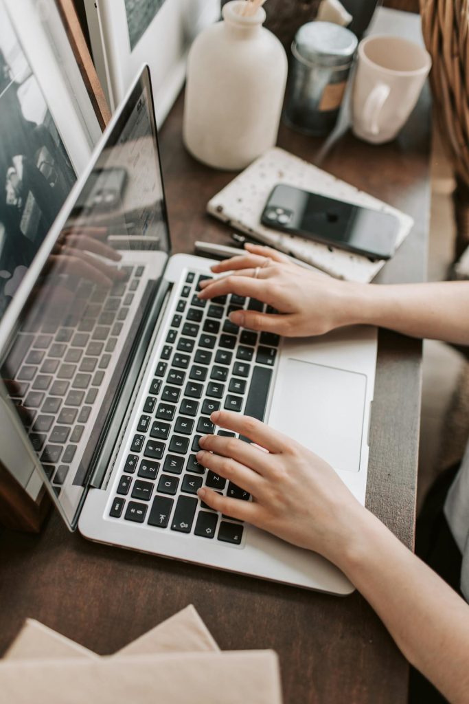 Freelancer working on a laptop while offering discounted services to build testimonials and experience.
